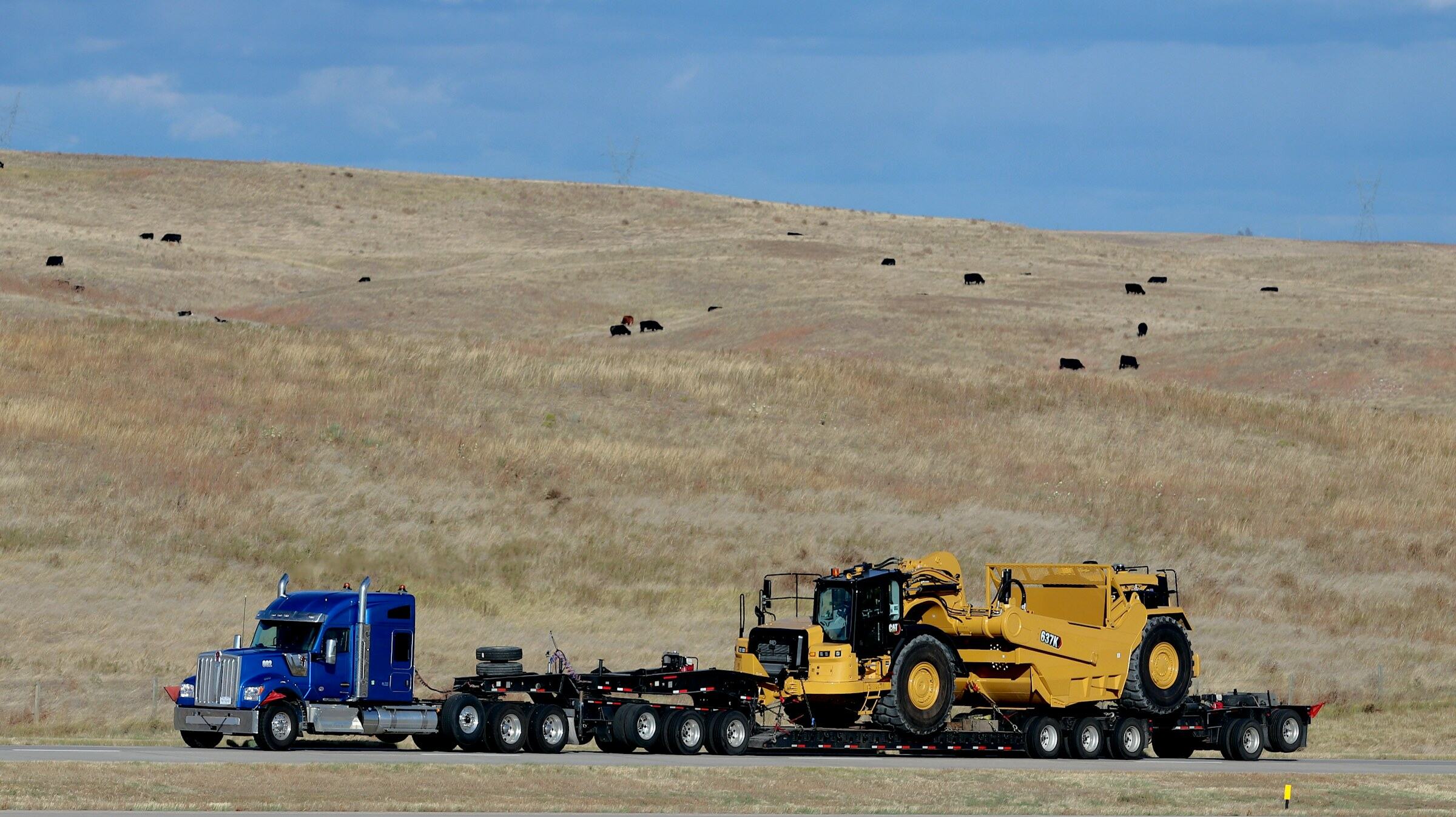 Heavy haul tractor pulling an oversized load on a lowboy trailer